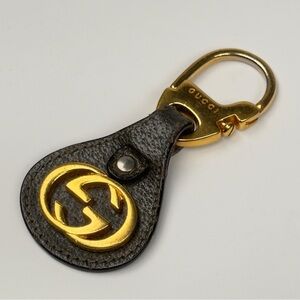 Gucci Black and Gold Logo Key Holder. Bag charm